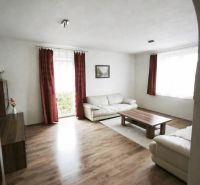Living room in a family house with sofas, a coffee table, and a wooden decor floor.