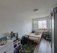 Children's room with light walls and a wooden decor floor in a 3-room apartment.