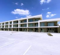 In Galanta, there is a three-story complex with parking space in front of the building.