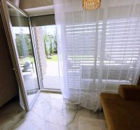 An open balcony in a 2-room apartment with marble-like tiles and stylish lighting.
