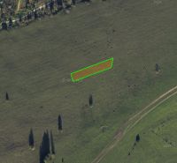 Agricultural and forest land in Čierny Balog with visible grassed area and road.