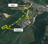 Aerial view of agricultural and forest lands in Čierny Balog with route marking.