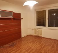 A room with a wooden decor floor, white walls, and a wall cabinet in a 3-room apartment.