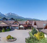 Hotel and guesthouse in Nová Lesná with a mountain backdrop.