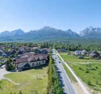A view of hotels and guesthouses in Nová Lesná with the High Tatras in the background.