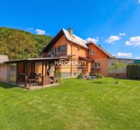 A family house in Dolná Mariková with a lawn and a gazebo in a natural setting.