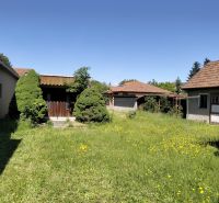 The family house on Štúrova Street in Sučany is surrounded by a lawn with dandelions.