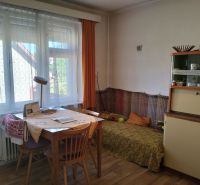 Interior of a family house with a dining table and a wooden decor floor.