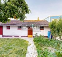A family house in Senica with a garden, trees, and a garden shed.