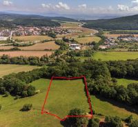 Recreational plots in Ostrá Lúka, surrounded by greenery and a village environment.