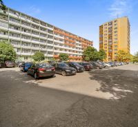 Parking lot with cars between apartment buildings on Československých Parašutistov Street in Bratislava - Nové Mesto.