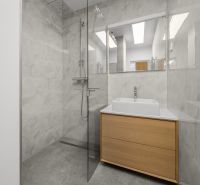 Bathroom with a shower and a sink in a 3-room apartment, ceramic tiles.