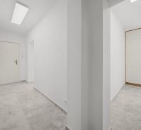 A hallway with white walls and a built-in wardrobe in a 3-room apartment.