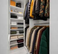 A well-organized closet with shelves and hangers in a 3-room apartment.