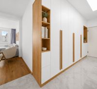 Living room with wood-patterned flooring and a built-in wardrobe in a 3-room apartment.