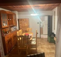 Dining area in a cabin with wooden furniture and lighting.