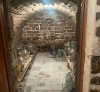 Stone cellar with an arched ceiling and shelves for storage, Cottage.