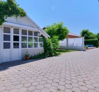 A family house in Žabokreky on Žabokreky Street with a paved yard and greenery.