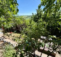 A garden by the cottage in Kunov, Senica, with swings and a view of the hills.