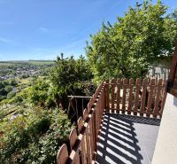 View from the terrace of the cottage in Kunovo, Senica, with a blooming garden and greenery.
