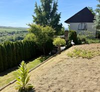 Garden by the cottage in Kunov, Senica with a view of the surrounding countryside and village.