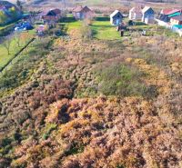 Aerial view of residential plots in Radnovce with rural houses and greenery.