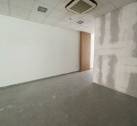 Offices with white walls and tile-patterned flooring.