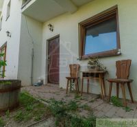 The exterior of a family house in Bernolákovo with a terrace and wooden furniture.