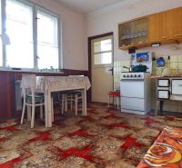 A kitchen in a family house with antique furnishings and a carpet, wooden decor.