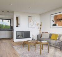 Living room of a family house with a wooden decor floor, light-colored sofa, and fireplace.