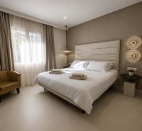 Bedroom in a 4-room apartment with a double bed, light flooring, and neutral curtains.