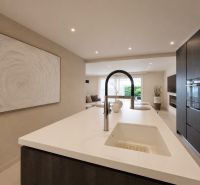 A kitchen in a 4-room apartment with an island and built-in appliances.
