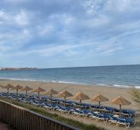 The beach at Dominion Beach in Estepona with sunbeds and umbrellas by the sea.