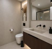 Bathroom with a shower and a sink with a mirror in a 4-room apartment.