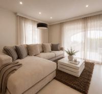 A bright living room in a 4-room apartment with a comfortable sofa and a coffee table.