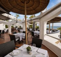 Terrace with a sea view at Dominion Beach in Estepona by a 4-bedroom apartment.