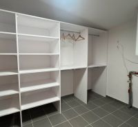 Cabinet with shelves and a boiler in the Recreational Apartment.