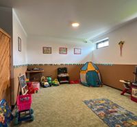 Children's corner in the Recreational Apartment with toys and a tent for children's entertainment.