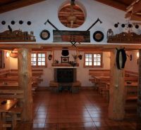 The interior of a restaurant in hotels and guesthouses with wooden elements and a fireplace.