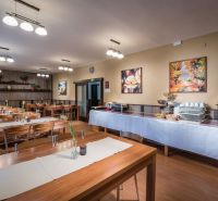 Dining room with a buffet table and wooden decor flooring in hotels and guesthouses.