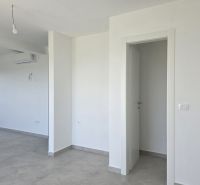 A white room in a 4-room apartment with air conditioning and ceramic flooring.