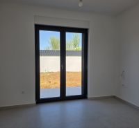 A room in a 4-room apartment with a large window and tiled floor.