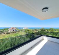 A balcony in a 4-room apartment in Privlaka with a view of the sea and greenery.