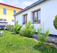 A family house in Košťany nad Turcom with a well-maintained garden and garden furniture.