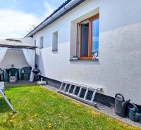 The courtyard of a family house in Košťany nad Turcom, garden swing, gazebo, lawn.
