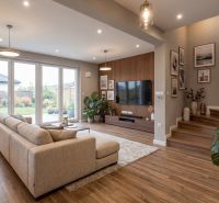 Living room in a family house with a wooden decor floor and a view of the garden.