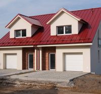A family house in Andovce with a red roof and a double garage in a peaceful location.