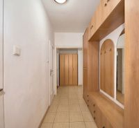 An entrance hall with a built-in wardrobe and tiled floor in a 2-room apartment.