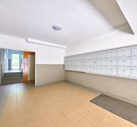 Lobby with mailboxes and entrance to the elevator in an apartment building.