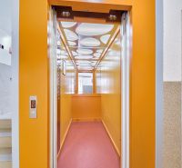 Yellow interior of the elevator next to the staircase, typical for Kyjevská in Bratislava - Nové Mesto.